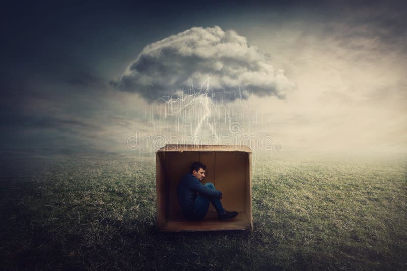 Surreal concept with a scared guy shelters inside a cardboard box. Introvert man caged by own fears as a thunderstorm cloud