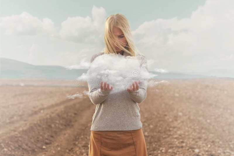 Surreal moment of a woman holding a cloud in her hands royalty free stock photo Surreal moment of a woman holding a cloud in her hands royalty free stock photo