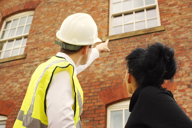 Surveyor builder homeowner looking at property stock images Surveyor builder homeowner looking at property stock images