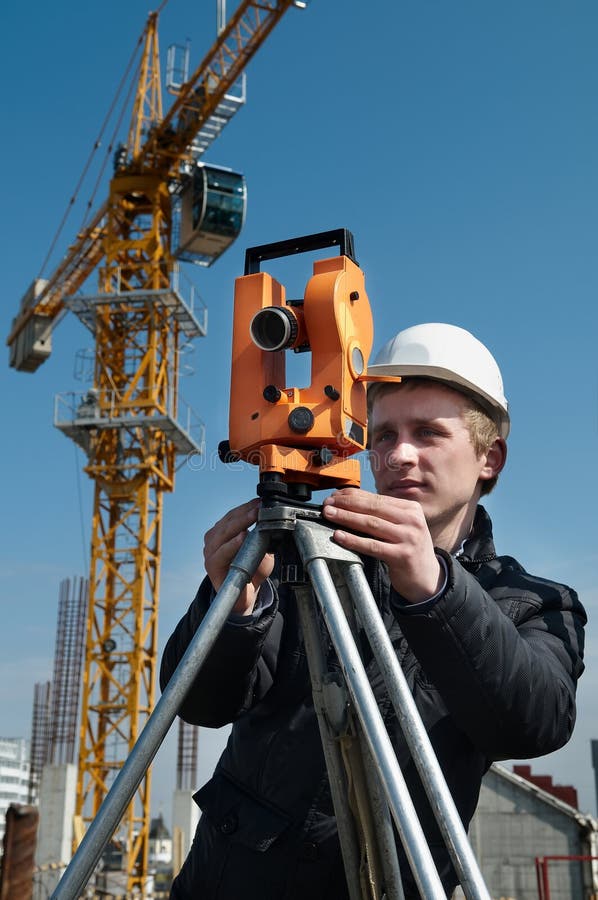 Worker surveyor measuring distances, elevations and directions on construction site by theodolite level transit equipment. Worker surveyor measuring distances, elevations and directions on construction site by theodolite level transit equipment