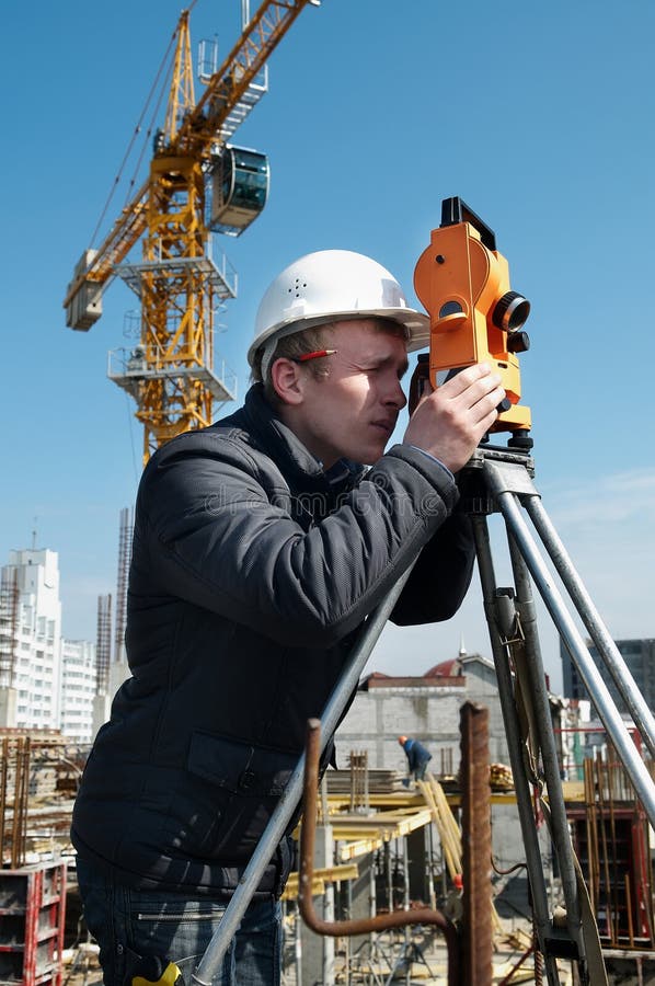 Worker surveyor measuring distances, elevations and directions on construction site by theodolite level transit equipment. Worker surveyor measuring distances, elevations and directions on construction site by theodolite level transit equipment