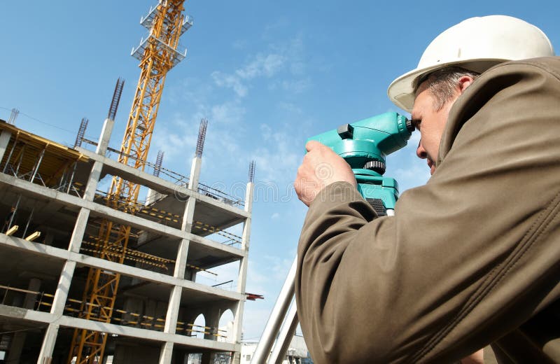 Worker surveyor measuring distances, elevations and directions on construction site by theodolite level transit equipment. Worker surveyor measuring distances, elevations and directions on construction site by theodolite level transit equipment