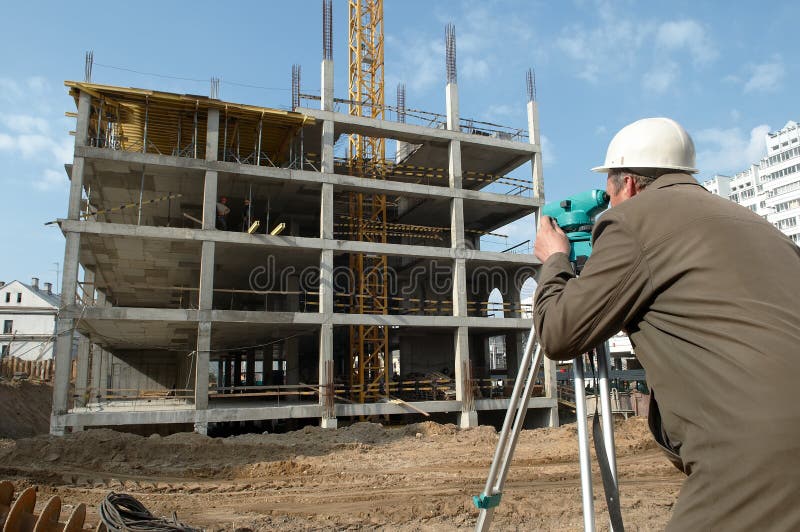 Worker surveyor measuring distances, elevations and directions on construction site by theodolite level transit equipment. Worker surveyor measuring distances, elevations and directions on construction site by theodolite level transit equipment