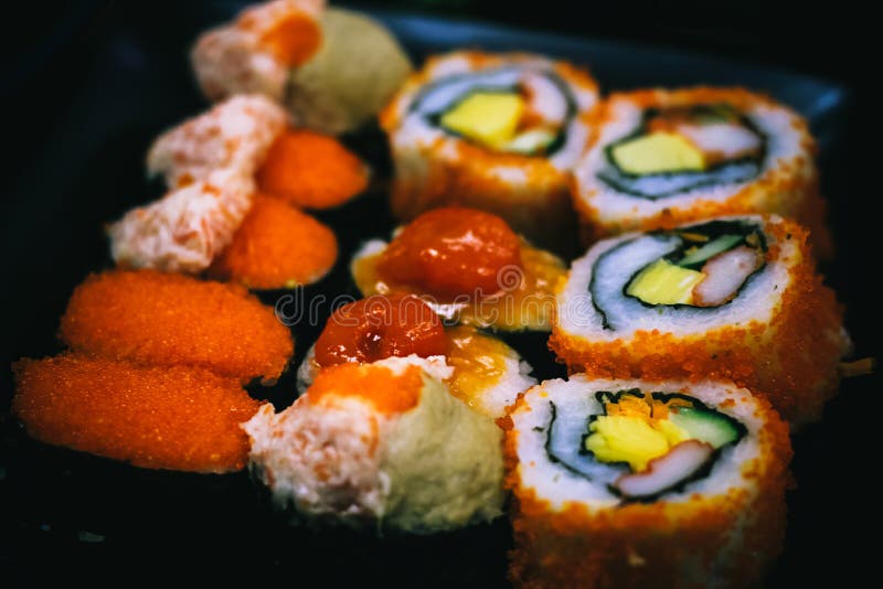 Sushi is Arranged on a Plate in a Japanese Restaurant. Stock Photo