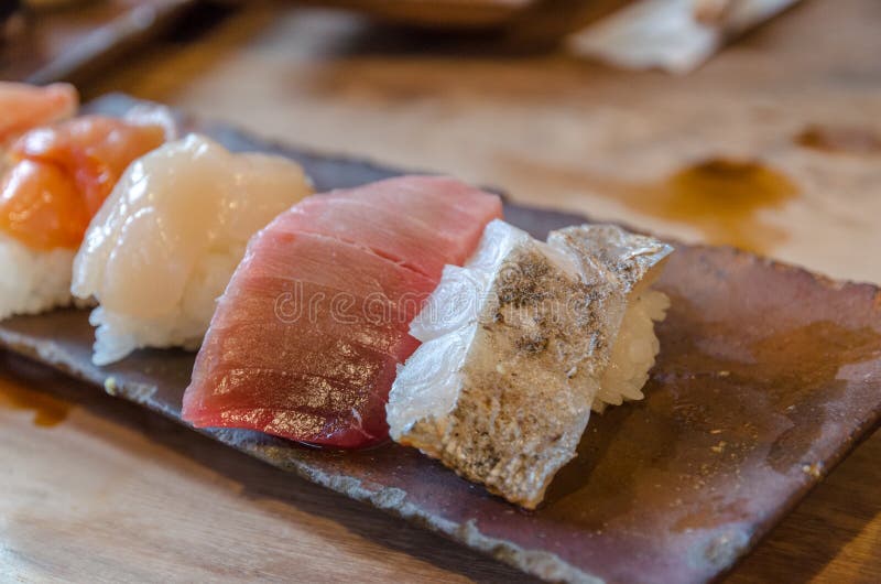Sushi on the black dish stock image. Image of delicacy 59256237