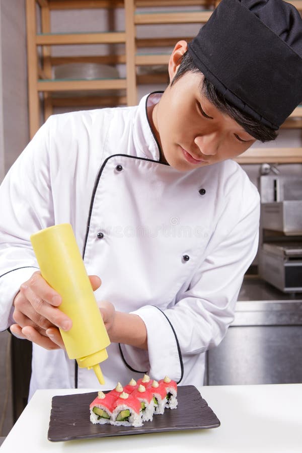 Sushi cook pours sauce stock photo. Image of cuisine 53123828