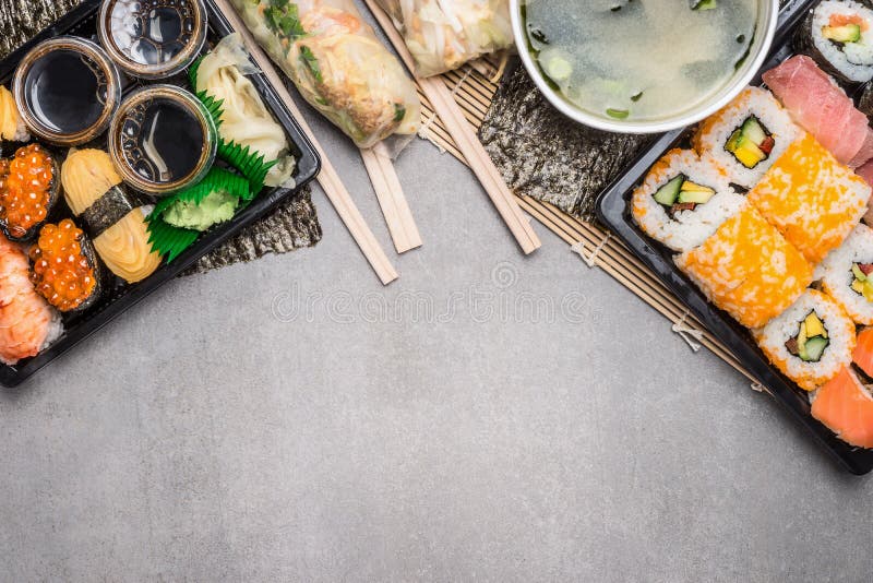 Sushi menu with summer rolls in rice paper wrappers and miso soup on gray on gray stone background, top view, border royalty free stock image Sushi menu with summer rolls in rice paper wrappers and miso soup on gray on gray stone background, top view, border royalty free stock image