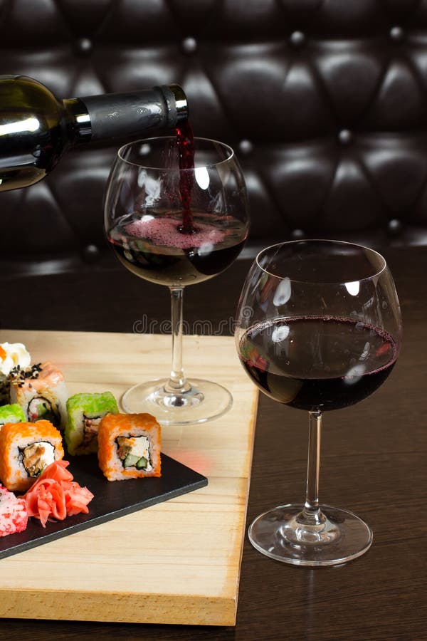 Sushi Mix Served Dinner, Red Wine on Table at Restaurant Stock Image