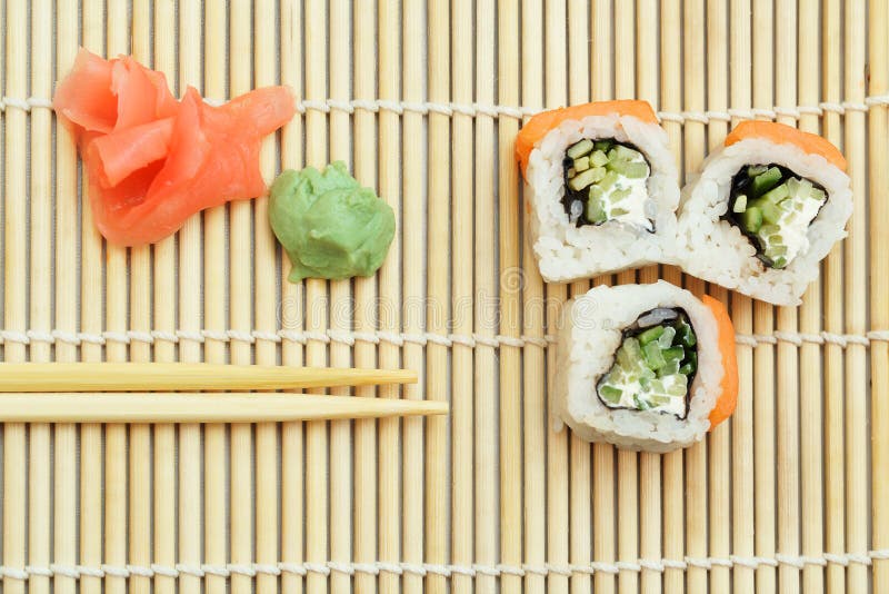 Sushi roll on bamboo mat stock photo. Image of cucumber 39155824