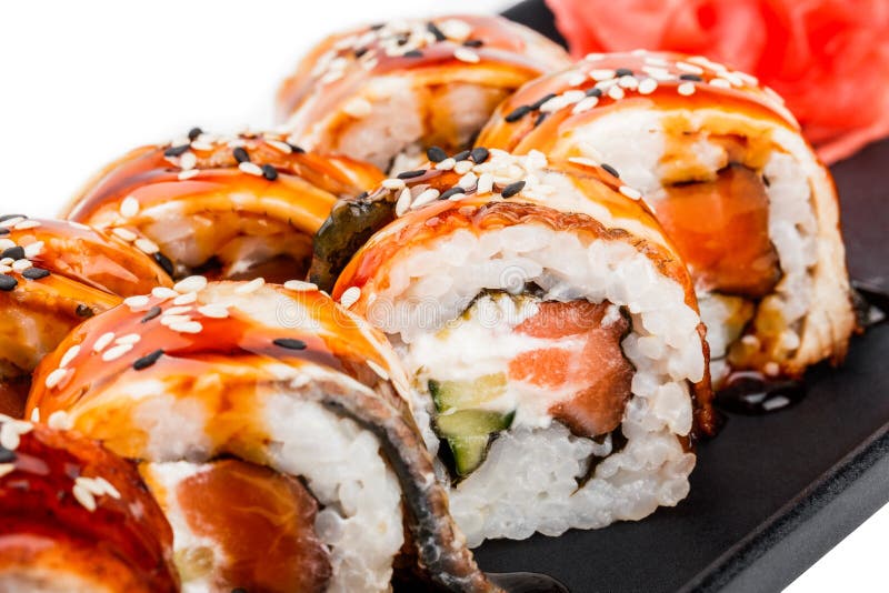 Sushi Roll - Maki Sushi made of salmon, smoked eel, cucumber, avocado and cream cheese on black plate. Isolated over white background. Japanese cuisine stock photography Sushi Roll - Maki Sushi made of salmon, smoked eel, cucumber, avocado and cream cheese on black plate. Isolated over white background. Japanese cuisine stock photography
