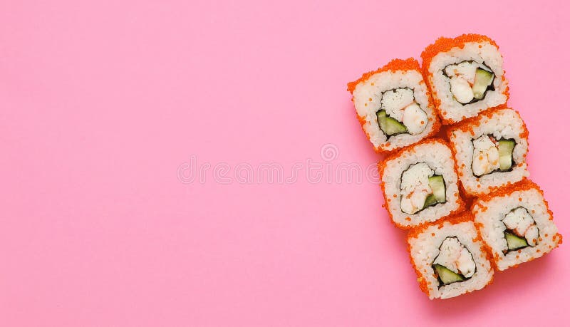 Sushi rolls on pink background with copy space.