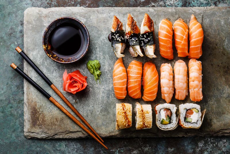 Sushi rolls set on stone slate stock photos Sushi rolls set on stone slate stock photos