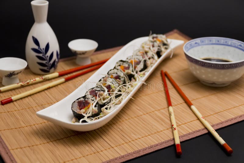 Sushi served with soya sprouts and sake