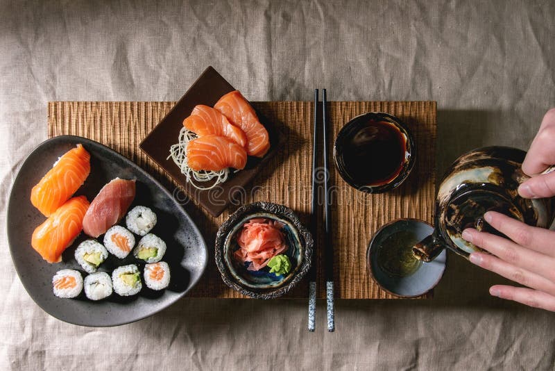 Sushi Set nigiri sashimi and sushi rolls on wooden serving board