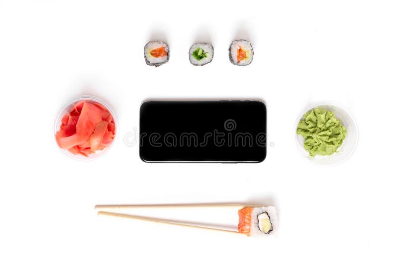 Sushi set rolls on white background chopsticks wasabi ginger phone delivery food concept royalty free stock photo Sushi set rolls on white background chopsticks wasabi ginger phone delivery food concept royalty free stock photo