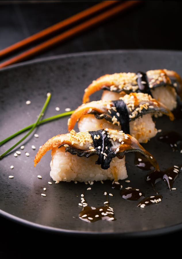 Sushi with smoked eel. Unagi nigiri with sauce