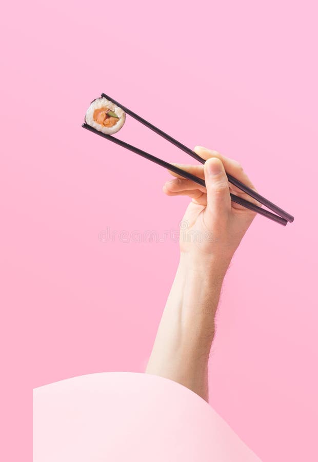 Sushi Takeaway Minimal Concept. Man Hand Holding Black Chopstick Pop Up  from Round Box with One Piece Rice Salmon and Cucumber Stock Photo - Image  of black, idea: 243413888