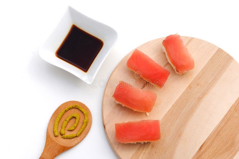 Sushi on wooden board with soy sauce and wasabi