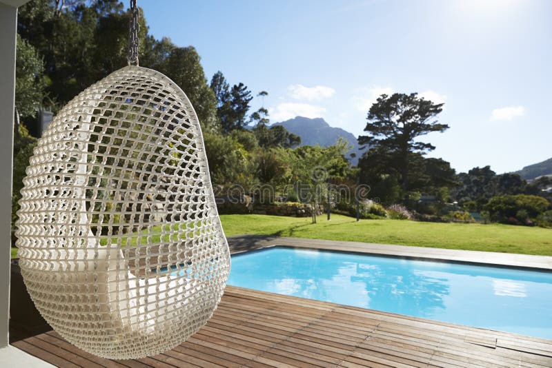 Suspended Seat Next To Decking Around Outdoor Swimming Pool