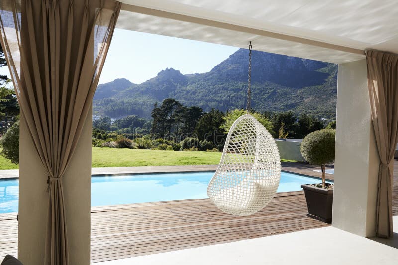 Suspended Seat Next To Decking Around Outdoor Swimming Pool