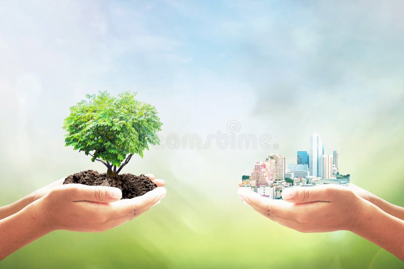 Sustainable development goals SDGs concept. Two human hand holding heart shape of tree and big city over blurred green nature background