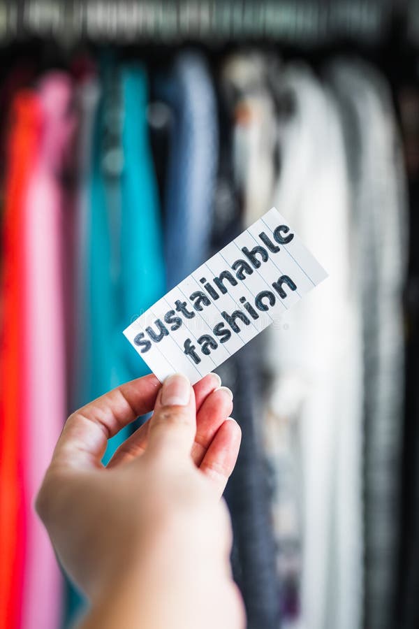 Ethical practices in the fashion industry, Sustainable Fashion held in front of wardrobe full of clothes stock image Ethical practices in the fashion industry, Sustainable Fashion held in front of wardrobe full of clothes stock image