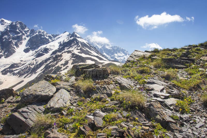 Svaneti rocky mountains landscape in Georgia on sunny summer day. Rocks and stones on hillside of mountain.