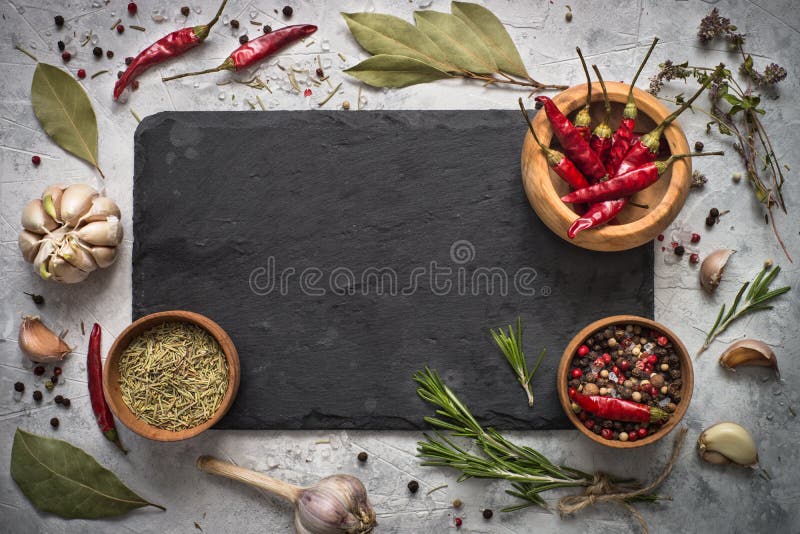 Black slate board, herbs and spices. Free space for menu or recipes. Cooking or food background. Black slate board, herbs and spices. Free space for menu or recipes. Cooking or food background.