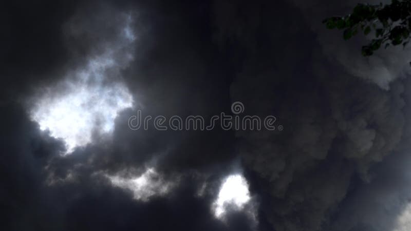 Black smoke rises into the sky. A big chemical fire at a factory building. Thick black smoke covers the sky. 4k. Black smoke rises into the sky. A big chemical fire at a factory building. Thick black smoke covers the sky. 4k