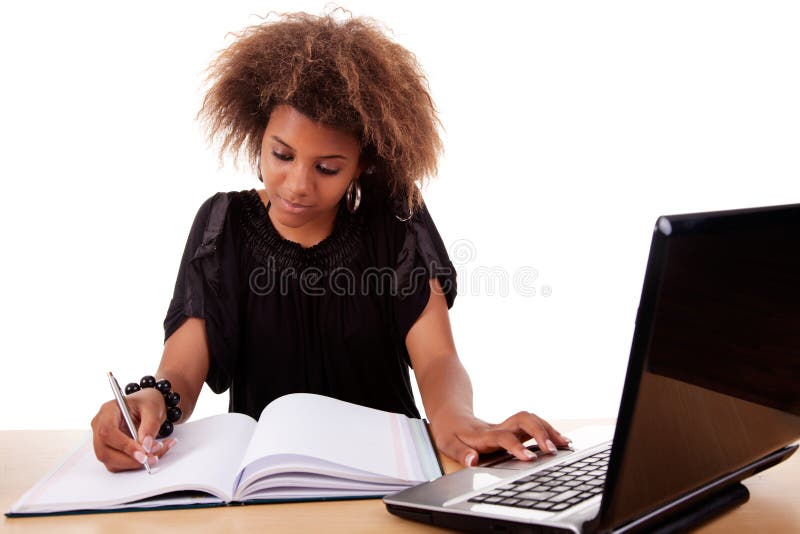 Young black women working on desk with computer, isolated on white background. Studio shot. Young black women working on desk with computer, isolated on white background. Studio shot.