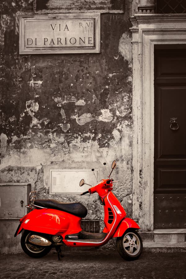Svartvit plats med en röd sparkcykel på en central Rome gata arkivbild Svartvit plats med en röd sparkcykel på en central Rome gata arkivbild