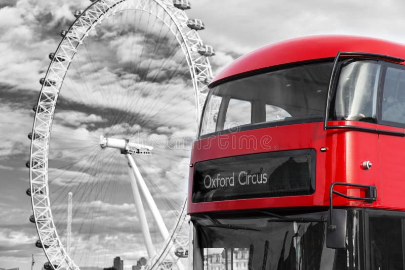 Black and white photo of the giant ferris wheel London Eye and a red bus crossing the Westminster bridge United Kingdom. Black and white photo of the giant ferris wheel London Eye and a red bus crossing the Westminster bridge United Kingdom