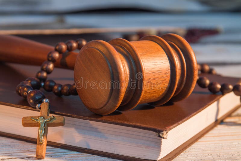 Swear to God, truth and nothing but truth. Wooden court hammer and crucifix cross with rosary on a bible book, sworn testimony. Swear to God, truth and nothing but truth. Wooden court hammer and crucifix cross with rosary on a bible book, sworn testimony.