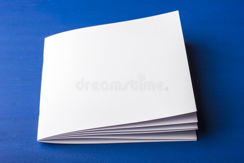 Svuoti il Libro Bianco per le note, il taccuino, il diario, il libretto, organizzatore su un fondo blu fotografia stock libera da diritti
