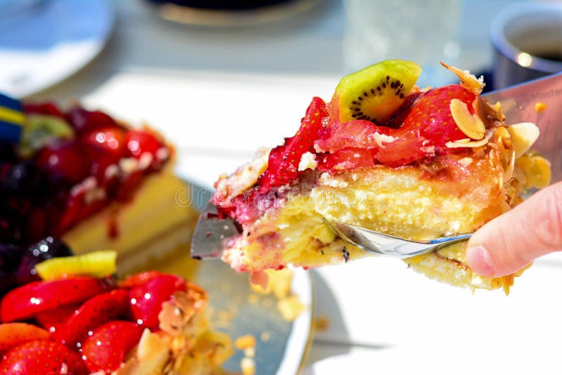 Swedish summer cake with cream, strawberries and fruit, garnished almonds around in thin slices. sun and copy space and swedish flags. Swedish summer cake with cream, strawberries and fruit, garnished almonds around in thin slices. sun and copy space and swedish flags