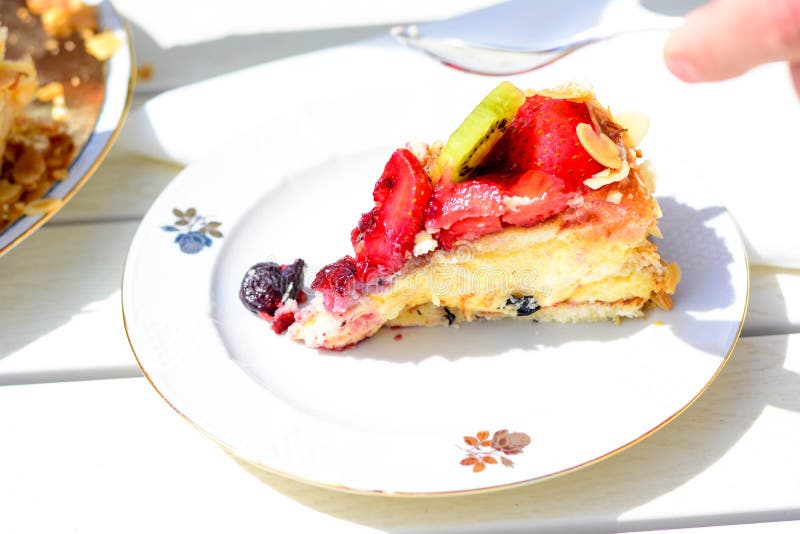 Swedish summer cake with cream, strawberries and fruit, garnished almonds around in thin slices. sun and copy space and swedish flags. Swedish summer cake with cream, strawberries and fruit, garnished almonds around in thin slices. sun and copy space and swedish flags