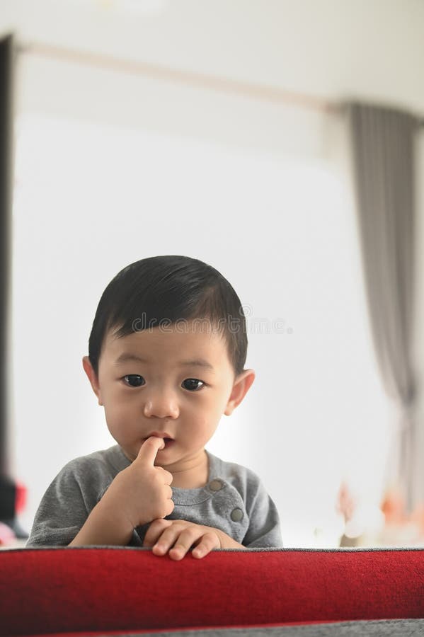 Boy With Fingers In His Mouth Stock Image - Image of 