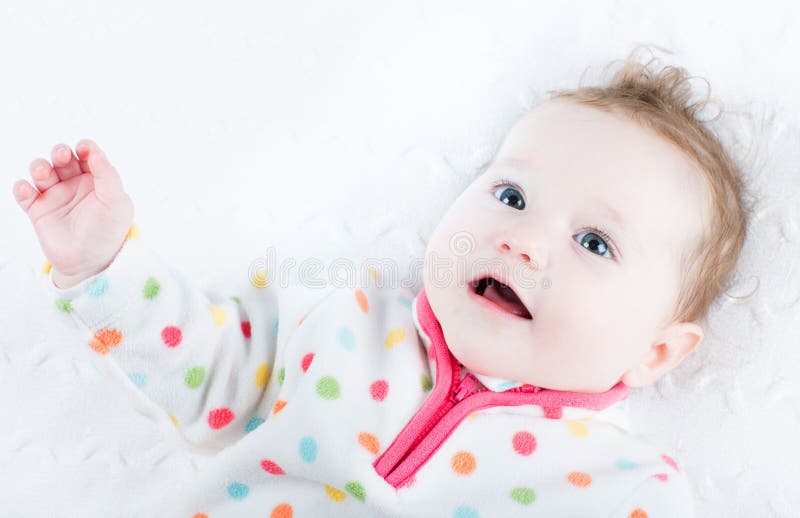 Sweet baby girl in a polka dots sweater