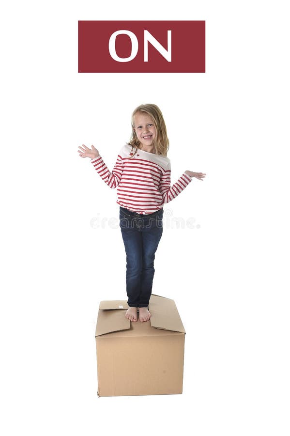 Sweet blond hair child stading on top of cardboard box isolated on white background in learning english stock photos Sweet blond hair child stading on top of cardboard box isolated on white background in learning english stock photos