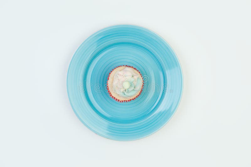 Sweet cake on a blue plate, top view on a white background. Copy space