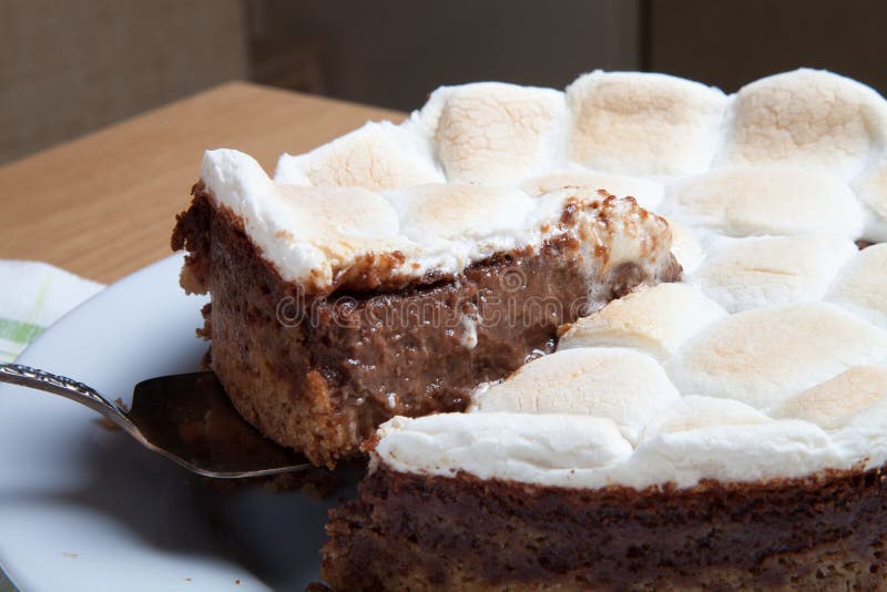 Sweet cake with chocolate on a light wooden table. Selective focus