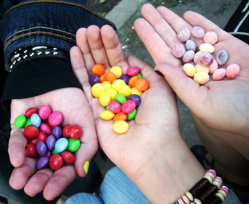 Sweet candies in the hands bright photo royalty free stock photo