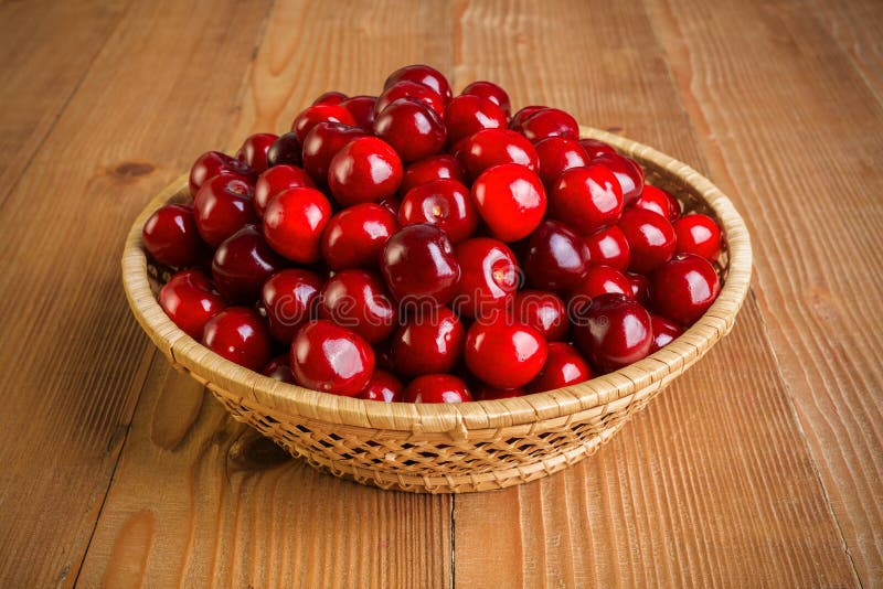 Sweet cherry berries (Prunus avium) in wicker plate