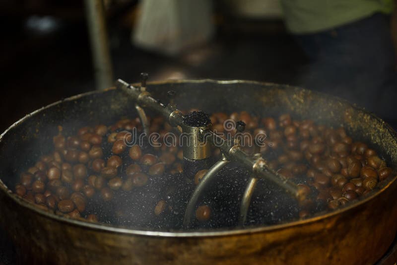 Sweet chestnut nuts roasting for eating in a turning drum.