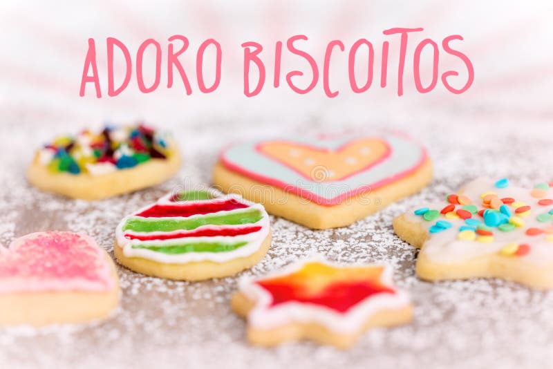 Sweet and colorful cookies on icing sugar background, spanish Te. Xt adoro biscoitos which means i love cookies royalty free stock image