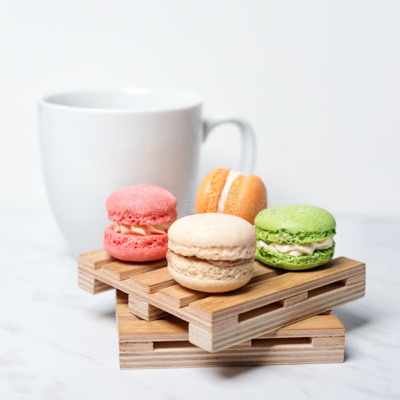 Sweet and Colourful Macaroons Served on Little Wooden Pallets with Cup ...