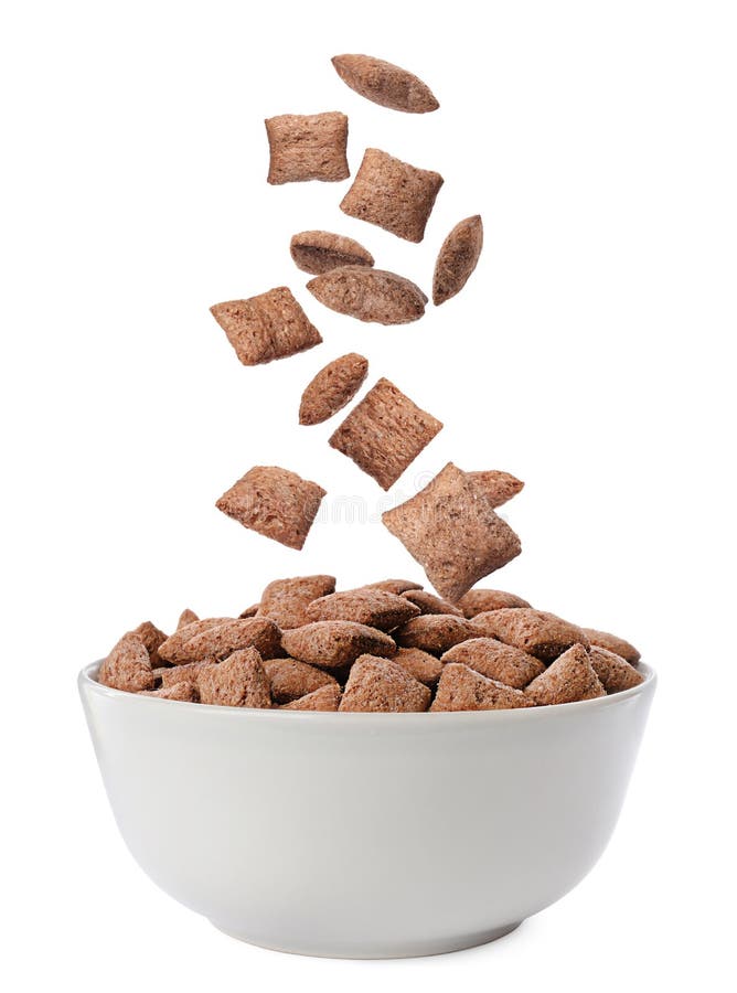 Sweet crispy corn pads falling into bowl on white background