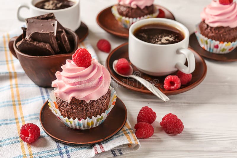 Sweet cupcake with raspberry, chocolate and cup of coffee on wooden table stock photography Sweet cupcake with raspberry, chocolate and cup of coffee on wooden table stock photography