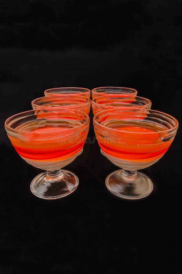 Sweet delicious dessert of multi-colored jelly in a glassware royalty free stock photos Sweet delicious dessert of multi-colored jelly in a glassware royalty free stock photos