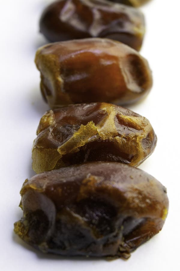 Sweet Dry Dates Laid Out in a Row, Isolated on White Background. Copy